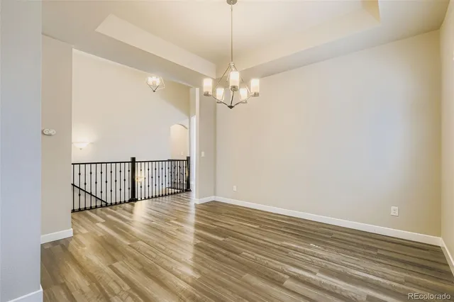 a view of a room with wooden floor fan and window