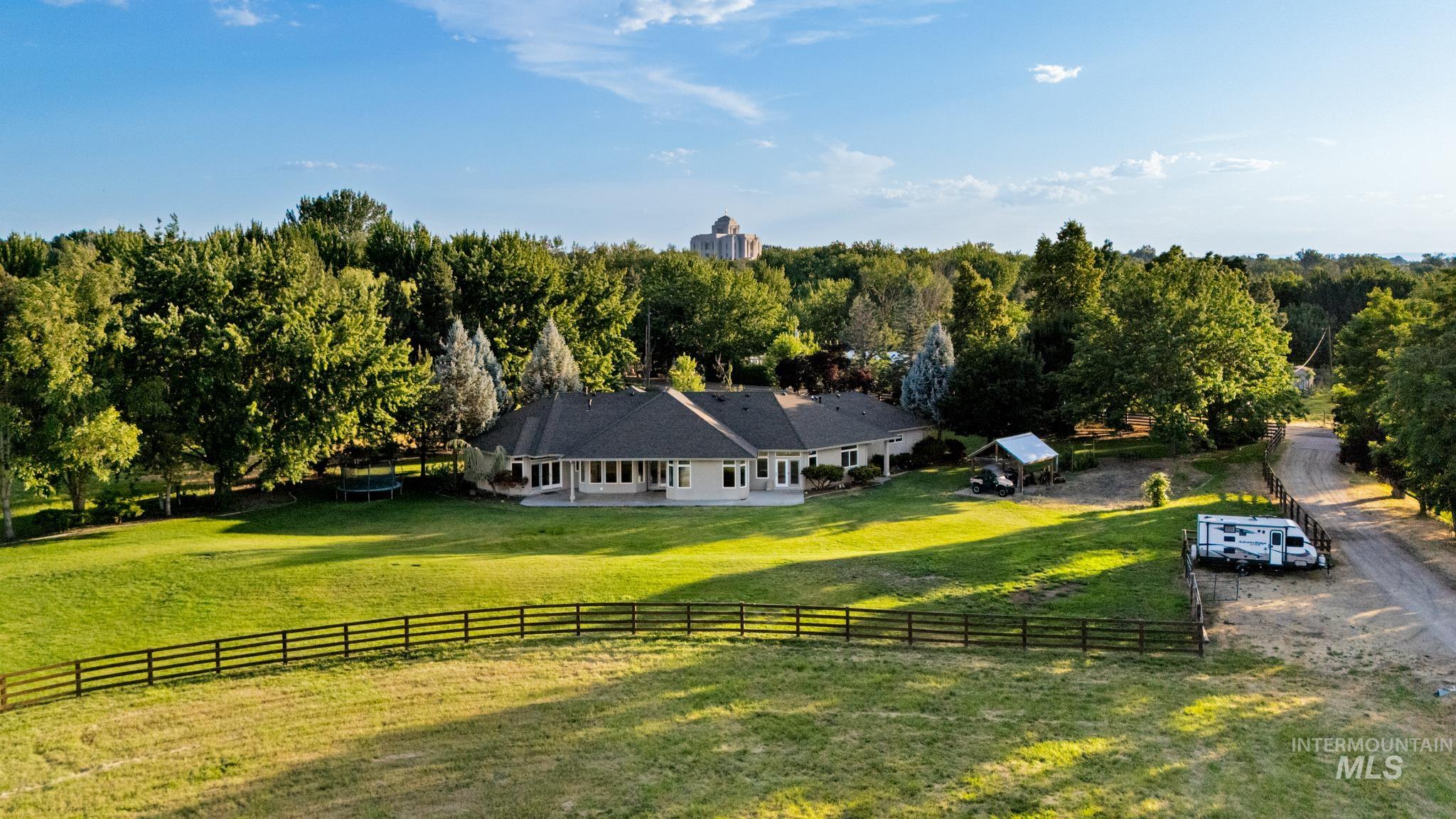 2050 Artesian Road Eagle, ID 83616 - Photo 5 of 49 Expansive manicured lawn featuring a perimeter fence and mature trees