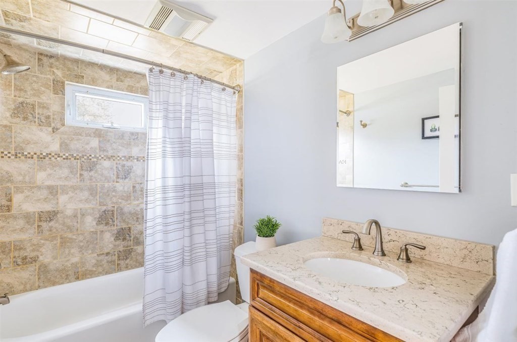 31 Gerard Road Norwell, MA 02061 - Photo 13 of 30 a bathroom with a granite countertop sink a toilet a mirror and shower