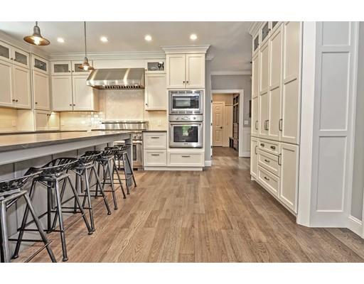 2 Snowy Owl Road Hopkinton, MA 01748 - Photo 5 of 30 a kitchen with stainless steel appliances granite countertop a stove top oven a sink and a refrigerator