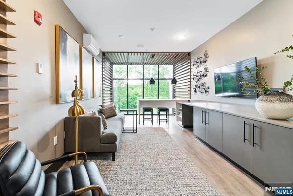 a living room with furniture large window and flat screen tv