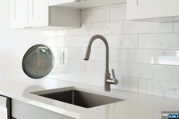 a close view of a sink and a vanity in front of mirror