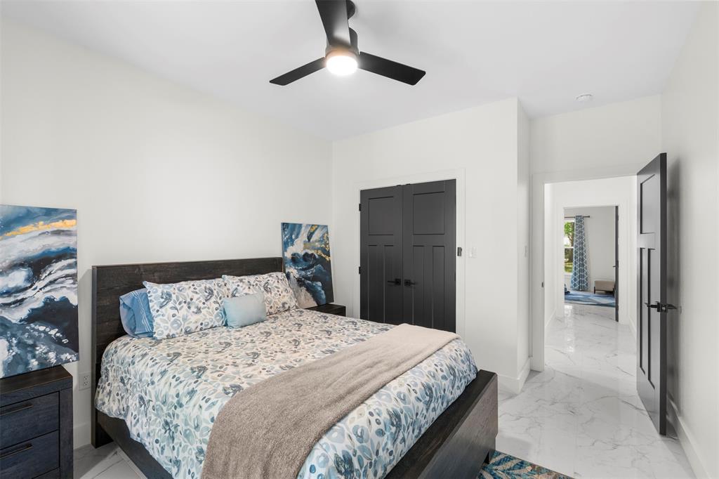 265 Shadow Oaks Streetman, TX 75859 - Photo 16 of 40 a bedroom with a bed and a chandelier