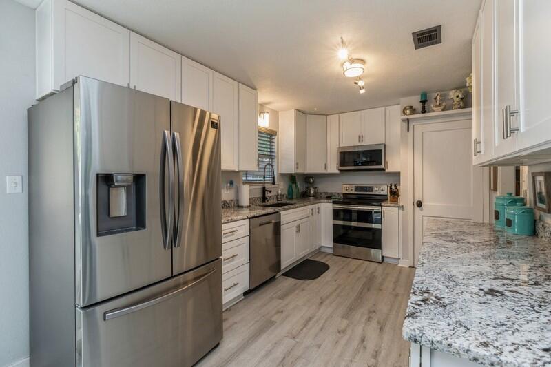 582 Woodlow Road Niceville, FL 32578 - Photo 11 of 30 a kitchen with stainless steel appliances a refrigerator sink and microwave