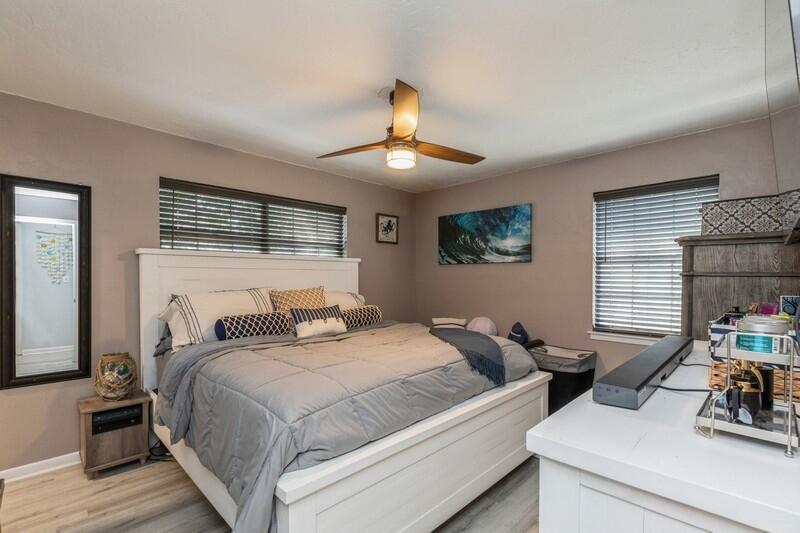 582 Woodlow Road Niceville, FL 32578 - Photo 15 of 30 a bedroom with a bed and a chandelier