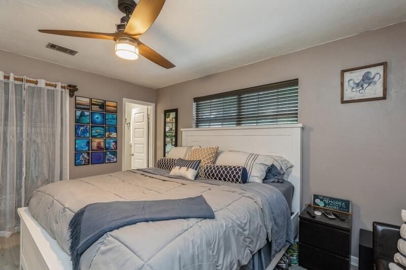 582 Woodlow Road Niceville, FL 32578 - Photo 16 of 30 a bedroom with a large bed and a chandelier