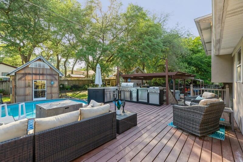 582 Woodlow Road Niceville, FL 32578 - Photo 30 of 30 a view of a patio with couches dining table and chairs with wooden floor