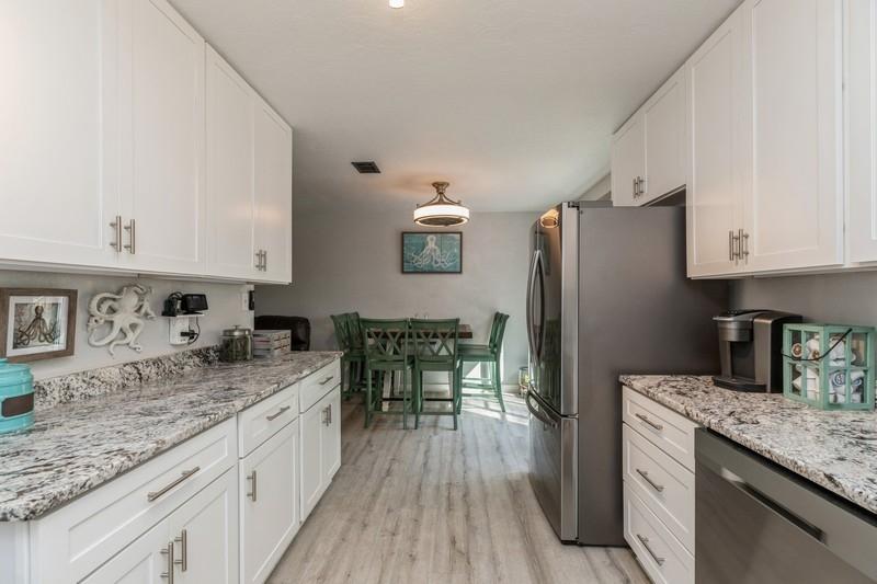 582 Woodlow Road Niceville, FL 32578 - Photo 9 of 30 a kitchen with stainless steel appliances granite countertop a refrigerator stove microwave and sink