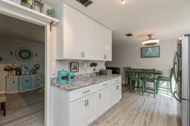 582 Woodlow Road Niceville, FL 32578 - Photo 10 of 30 a kitchen with a sink cabinets and wooden floor