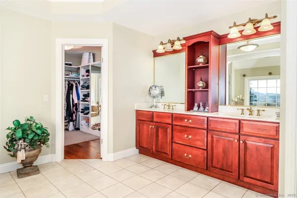 a spacious bathroom with a sink and mirror