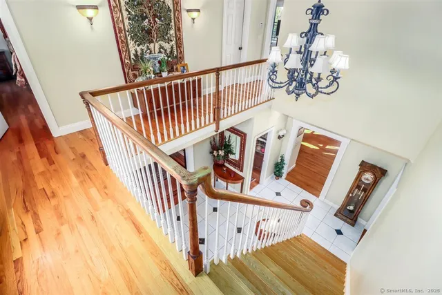 a bedroom with a bed wooden floor and window