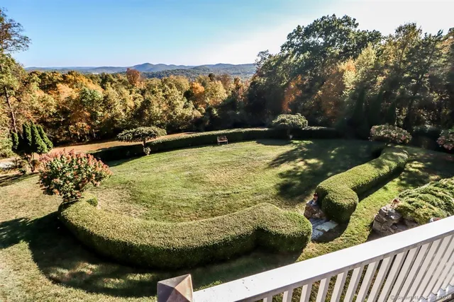 a living room with furniture and large windows