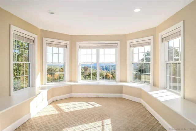 a view of a livingroom with furniture and a window