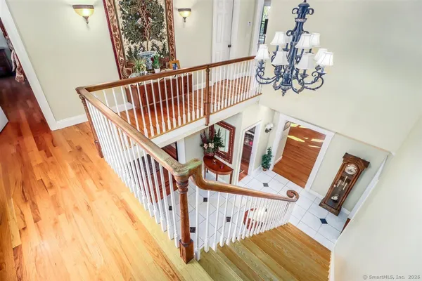 a bedroom with a bed wooden floor and window