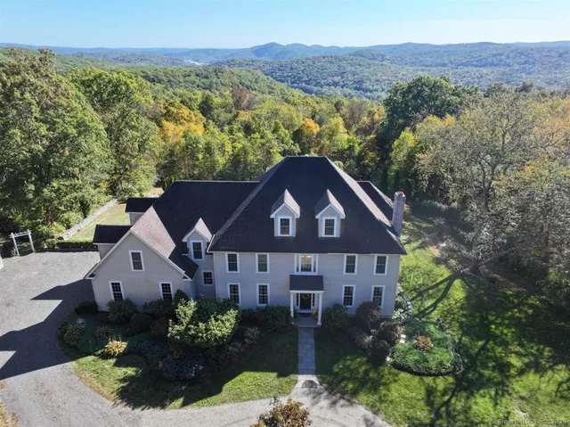 an aerial view of a house with garden space and street view