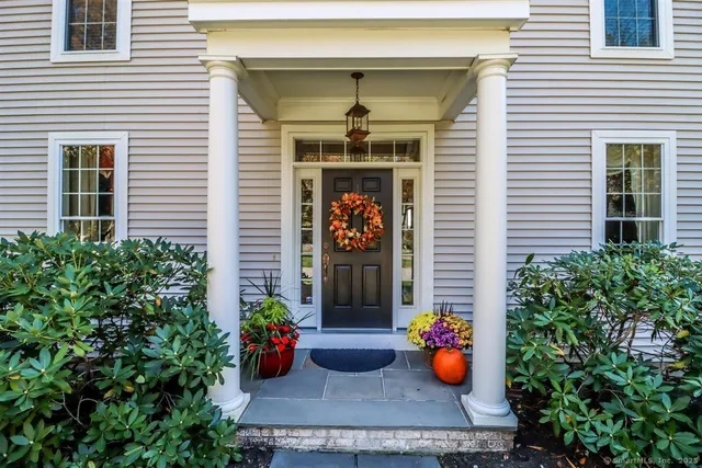 a front view of a house with outdoor seating