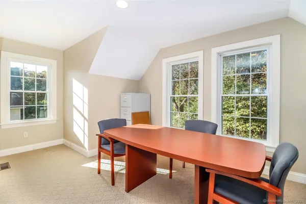 a view of a dining room with a table and chairs
