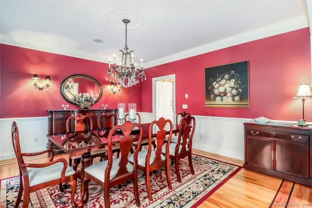 a view of a dining room with furniture and chandelier
