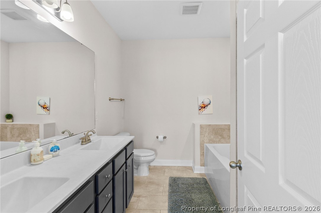 288 Gallery Drive, Unit 301 Spring Lake, NC 28390 - Photo 16 of 36 a bathroom with a sink toilet and shower