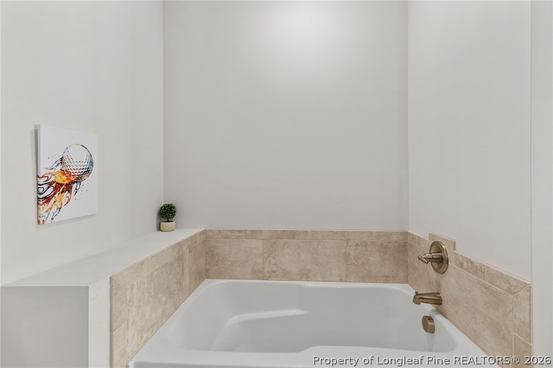 288 Gallery Drive, Unit 301 Spring Lake, NC 28390 - Photo 18 of 36 a bath tub sitting next to a white wall