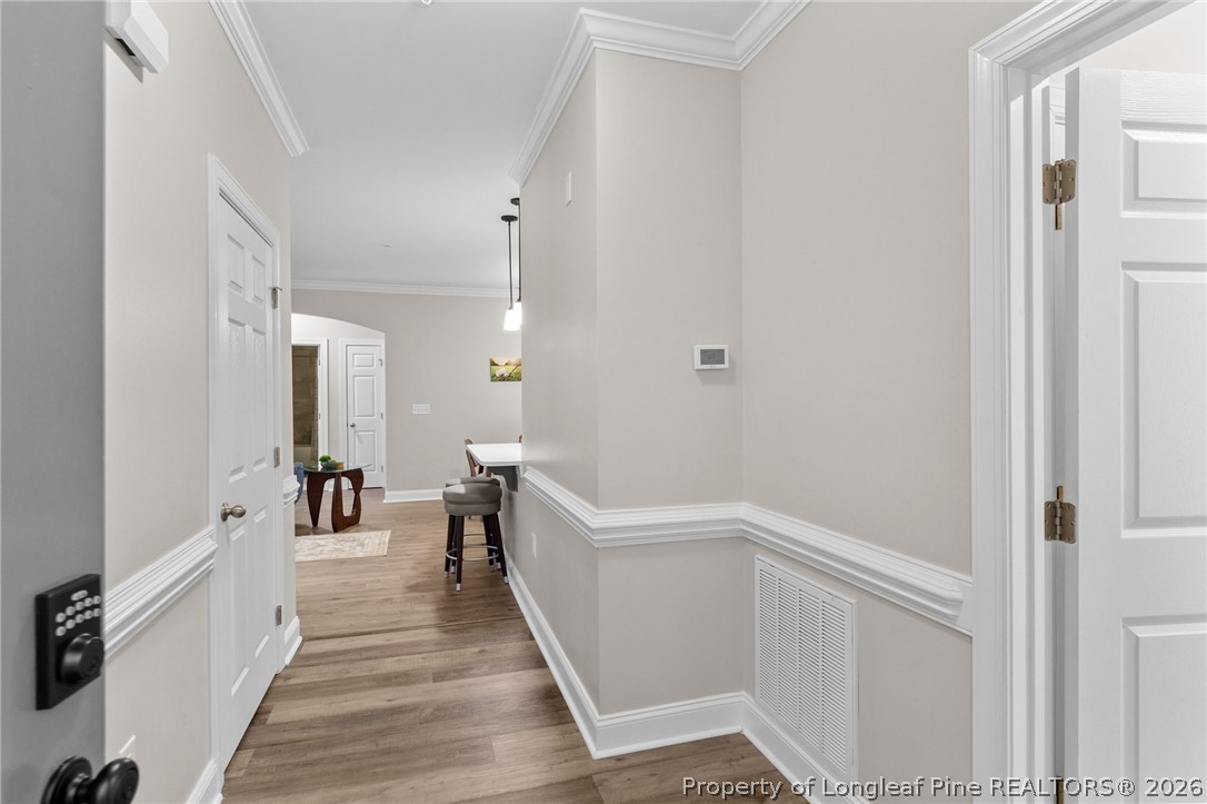 288 Gallery Drive, Unit 301 Spring Lake, NC 28390 - Photo 2 of 36 a hallway with white cabinets and wooden floor