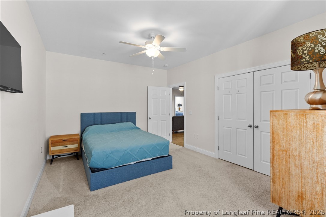 288 Gallery Drive, Unit 301 Spring Lake, NC 28390 - Photo 21 of 36 a bedroom with a bed and a chandelier