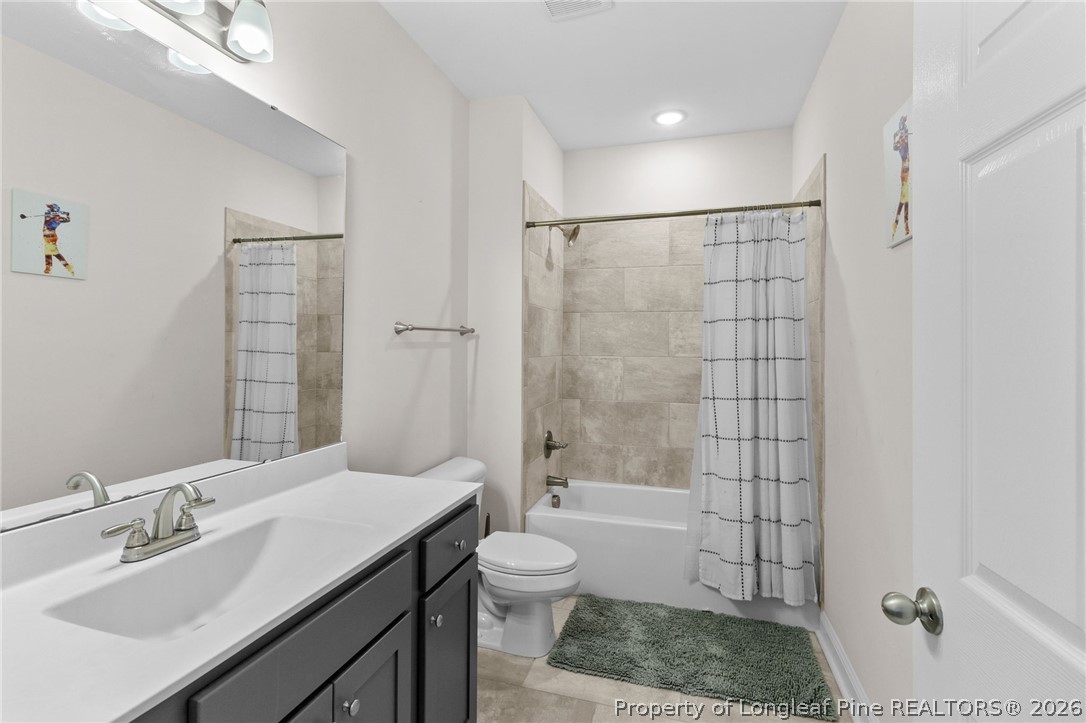 288 Gallery Drive, Unit 301 Spring Lake, NC 28390 - Photo 22 of 36 a bathroom with a sink a toilet and shower