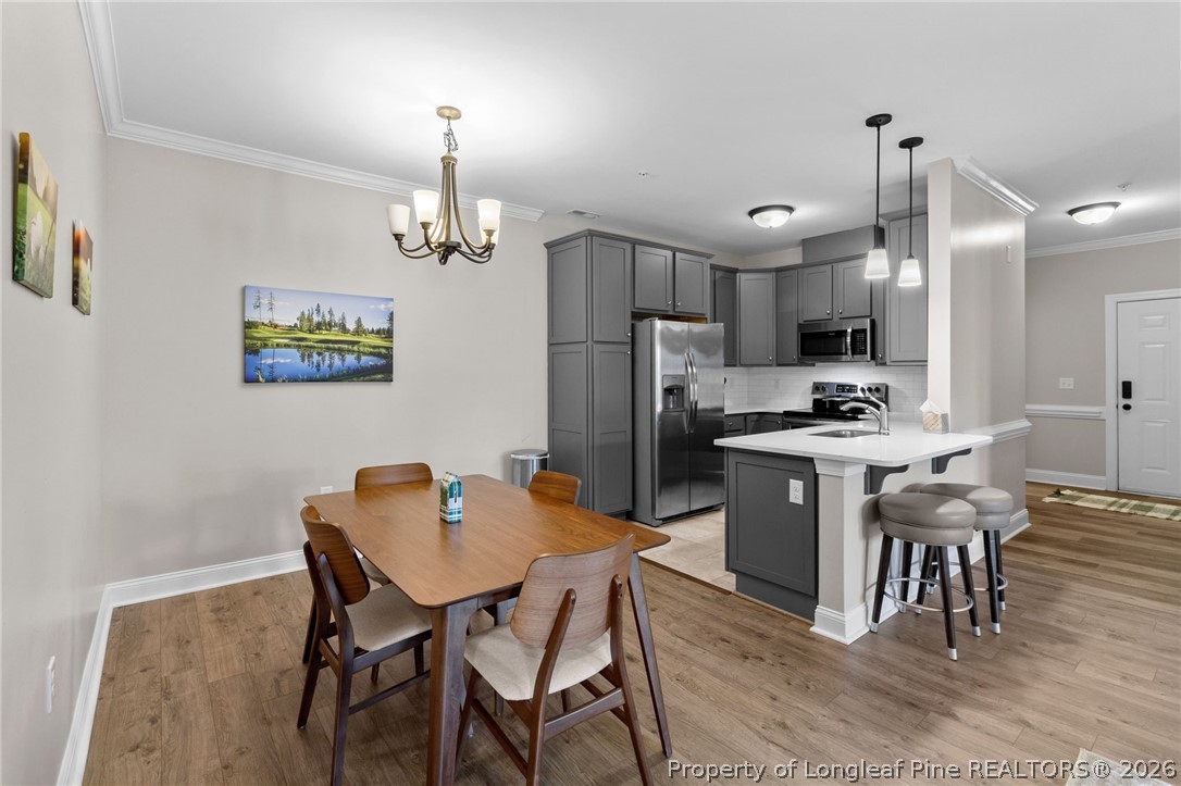 288 Gallery Drive, Unit 301 Spring Lake, NC 28390 - Photo 6 of 36 a kitchen room with stainless steel appliances kitchen island granite countertop a dining table chairs and a refrigerator
