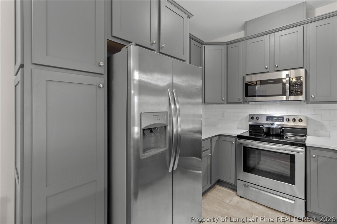 288 Gallery Drive, Unit 301 Spring Lake, NC 28390 - Photo 10 of 36 a kitchen with stainless steel appliances granite countertop a stove a refrigerator and a microwave