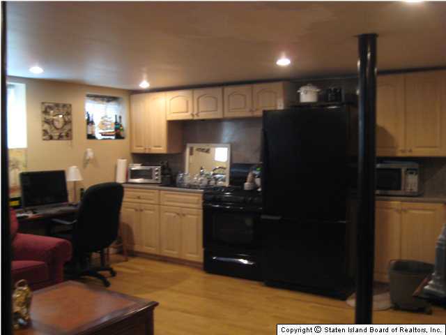 53 Belair Road Staten Island, NY 10305 - Photo 12 of 14 a kitchen with a refrigerator and cabinets