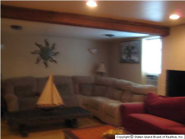53 Belair Road Staten Island, NY 10305 - Photo 13 of 14 a living room with furniture and a lamp