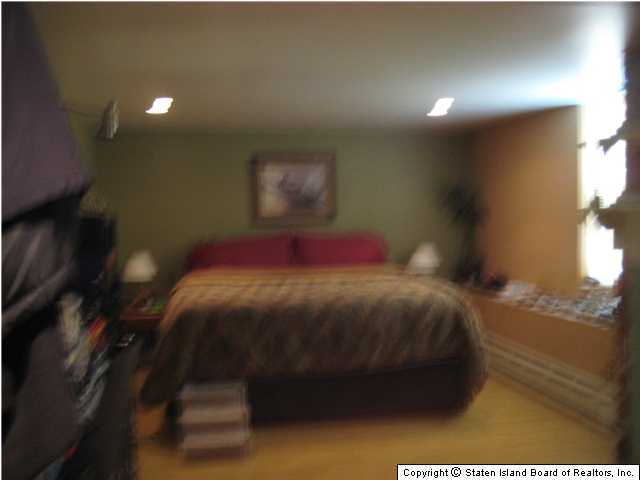 53 Belair Road Staten Island, NY 10305 - Photo 14 of 14 a bedroom with a bed and a night stand