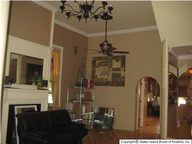 53 Belair Road Staten Island, NY 10305 - Photo 3 of 14 a living room with furniture a flat screen tv and a fireplace