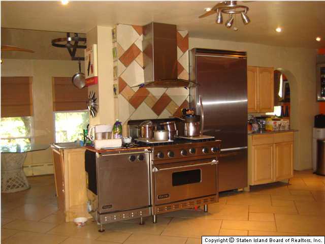 53 Belair Road Staten Island, NY 10305 - Photo 4 of 14 a kitchen with stainless steel appliances granite countertop a stove a refrigerator and a sink