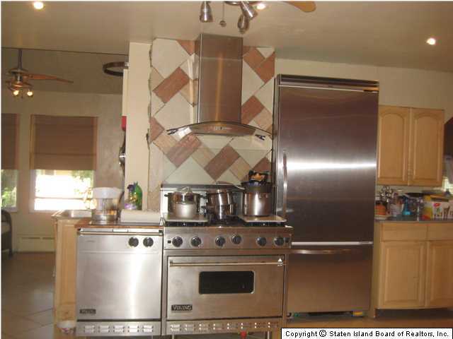 53 Belair Road Staten Island, NY 10305 - Photo 7 of 14 a kitchen with a stove and a refrigerator