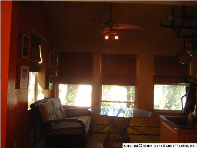 53 Belair Road Staten Island, NY 10305 - Photo 10 of 14 a living room with furniture and a large window