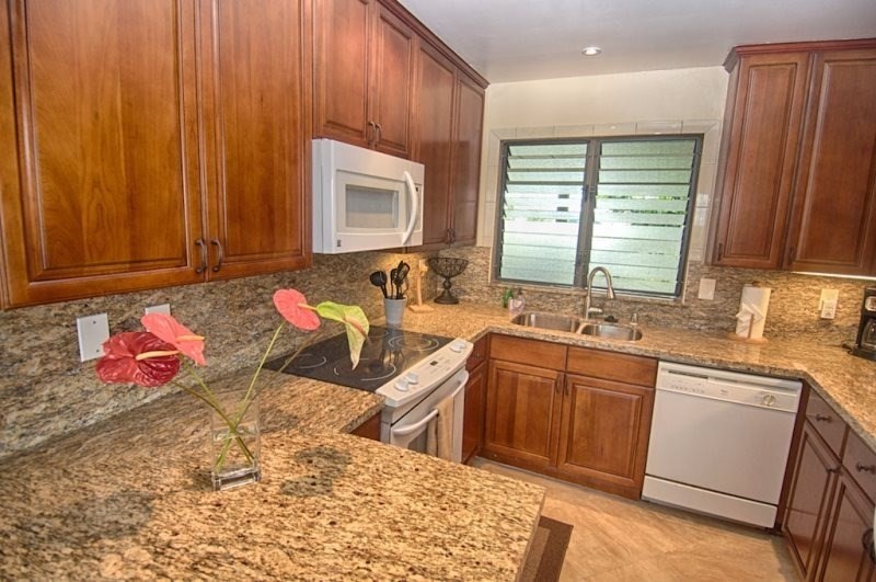 410 Papaloa Road, Unit 233 Kapaa, HI 96746 - Photo 11 of 13 a kitchen with a sink cabinets and window