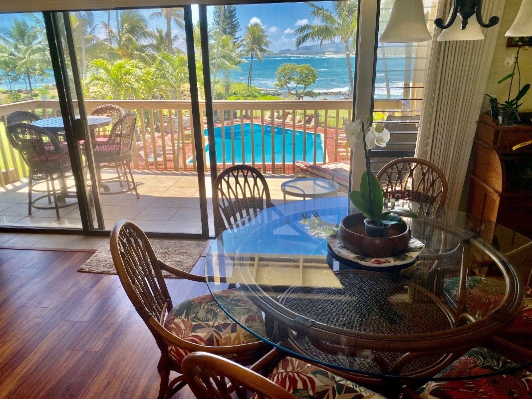 410 Papaloa Road, Unit 233 Kapaa, HI 96746 - Photo 3 of 13 a dining room with furniture wooden floor and a floor to ceiling window