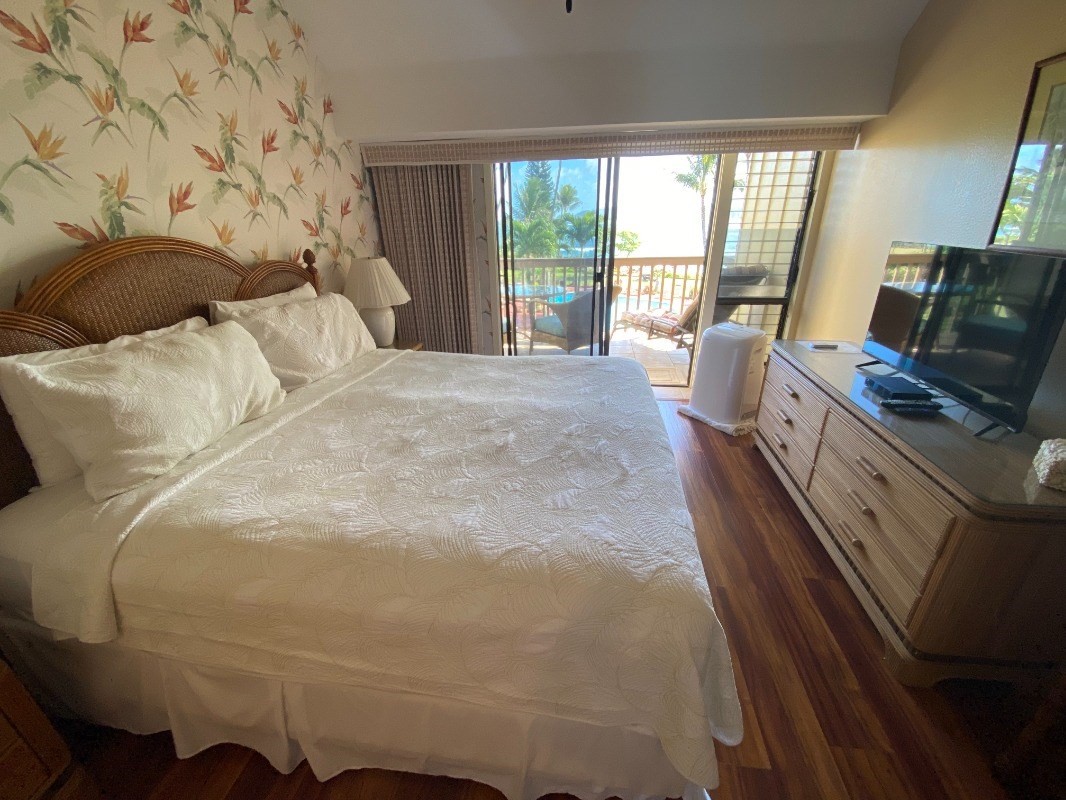 410 Papaloa Road, Unit 233 Kapaa, HI 96746 - Photo 5 of 13 a bed sitting in a bedroom next to a window with outer view