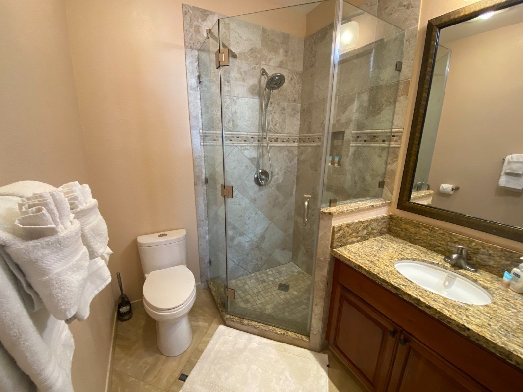 410 Papaloa Road, Unit 233 Kapaa, HI 96746 - Photo 6 of 13 a bathroom with a granite countertop sink toilet and shower