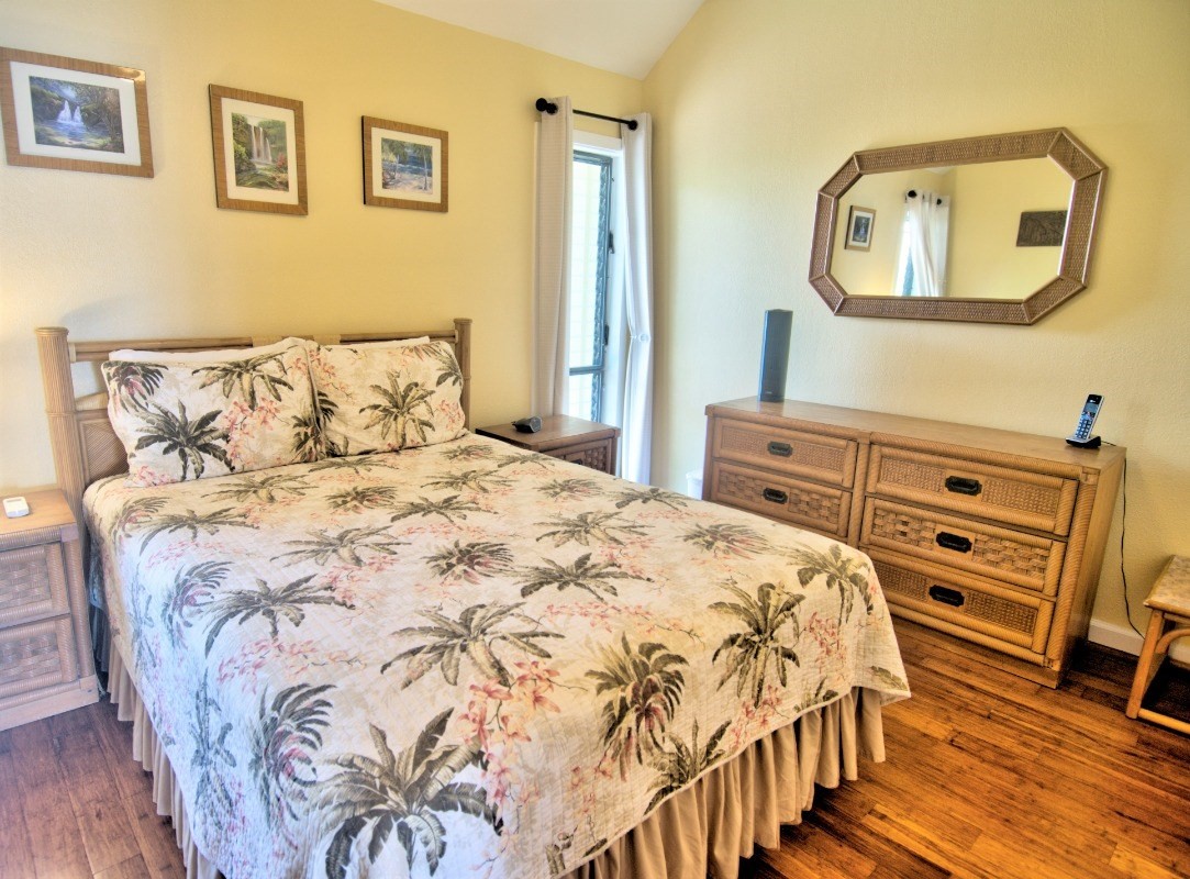 410 Papaloa Road, Unit 233 Kapaa, HI 96746 - Photo 7 of 13 a bedroom with a bed and a mirror