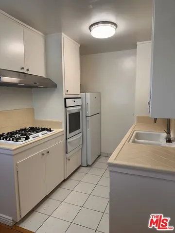 a kitchen with a stove and a refrigerator