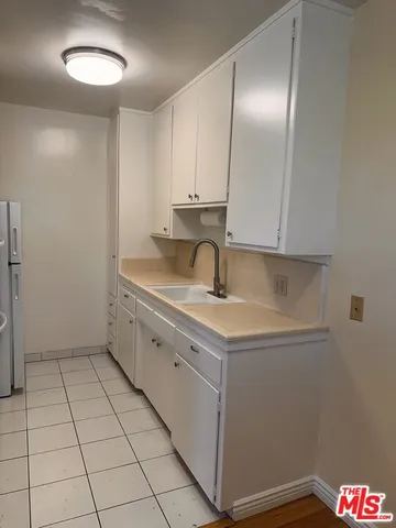 a kitchen with a sink cabinets and utility
