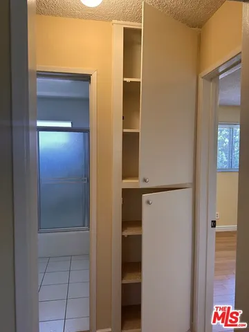 a view of a room that has wooden floor and a window