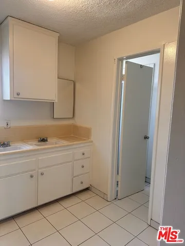 a kitchen with a sink cabinets and appliances