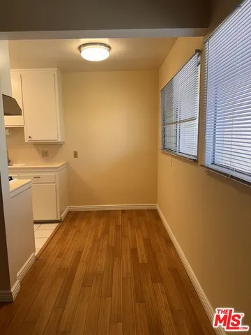 a view of a room with wooden floor and utility room