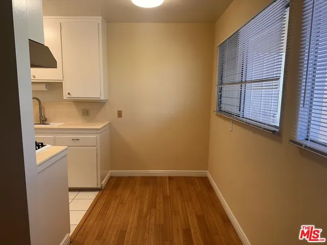 a room with a sink and wooden floor