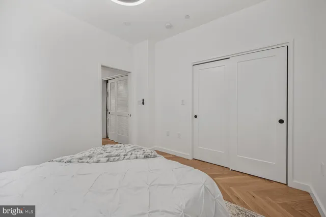 a bedroom with a bed and a mirror