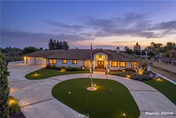 a view of a house with swimming pool and a yard