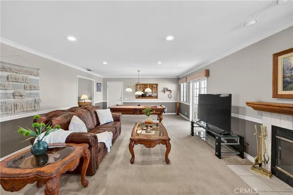 a living room with furniture a air conditioner vent and a window